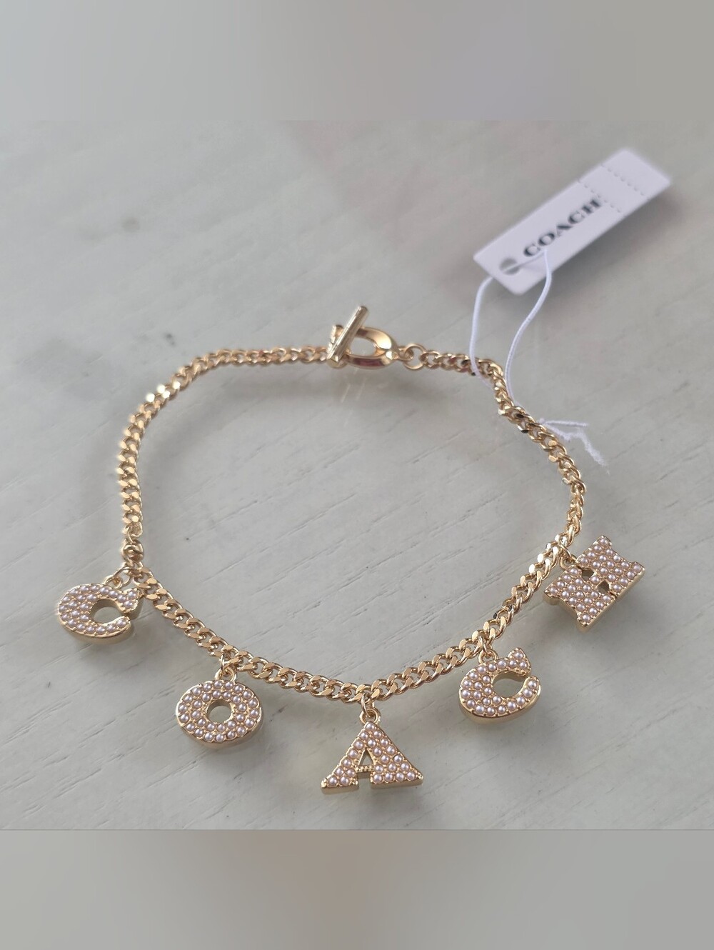 COACH Station Logo Charm Bracelet, Pearl Gold NWT Rare Pieces